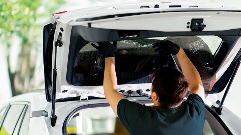 Nobleglass Monteur repariert kaputte Heckscheibe am Auto.